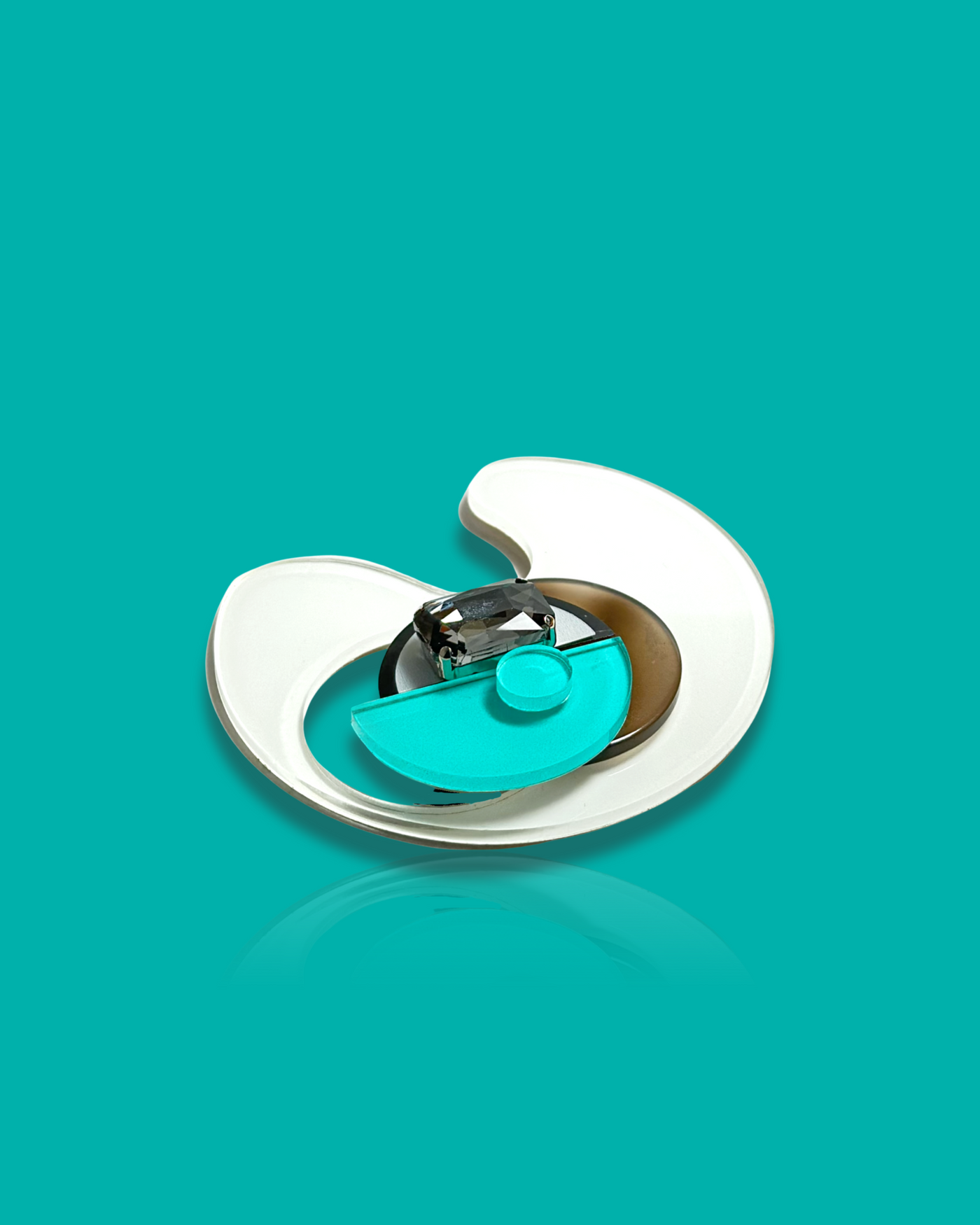 Geometric-shaped trendy brooch in cyan and white, modern abstract design.