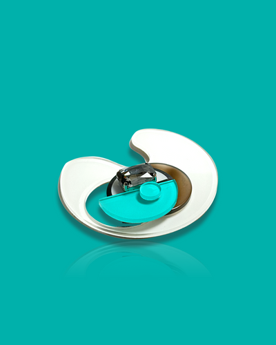 Geometric-shaped trendy brooch in cyan and white, modern abstract design.