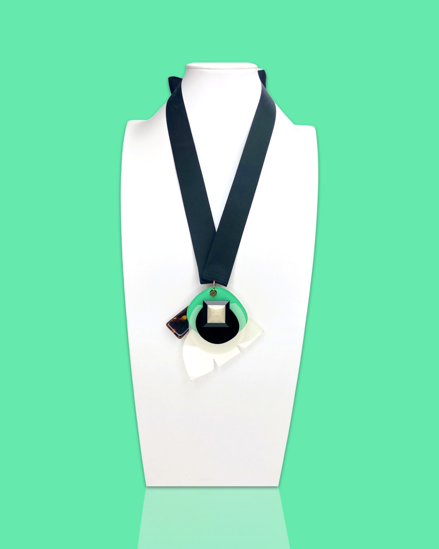 Stylish fashion necklace in seafoam colour with acrylic hardware and silk ribbon fastening.