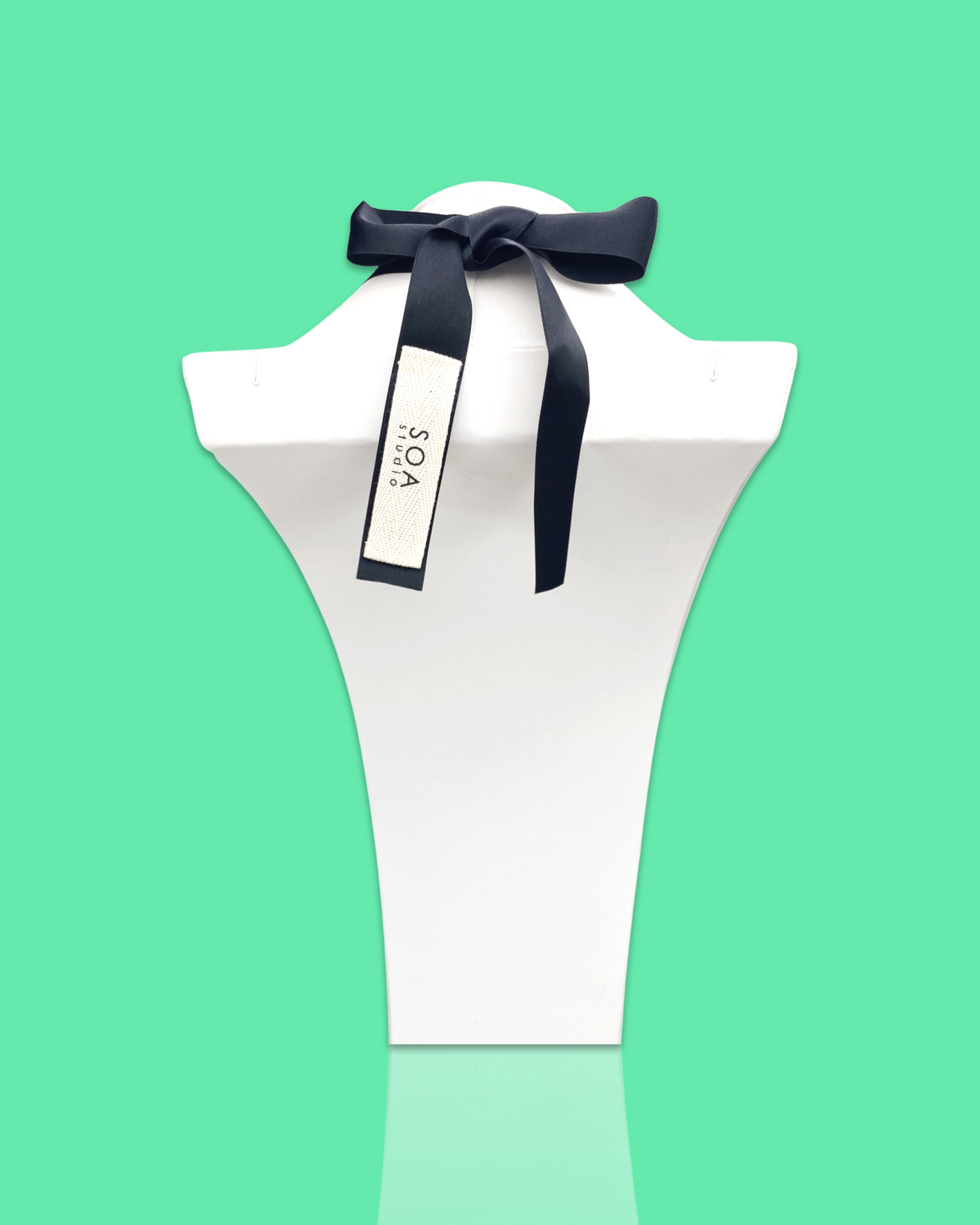 Seafoam color stylish fashion necklace with acrylic hardware and silk ribbon fastening.