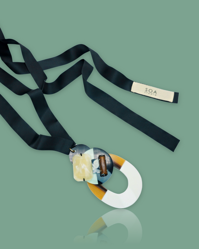 Chic bold classy mint-colored necklace with buffalo horn pendant and silk ribbon.