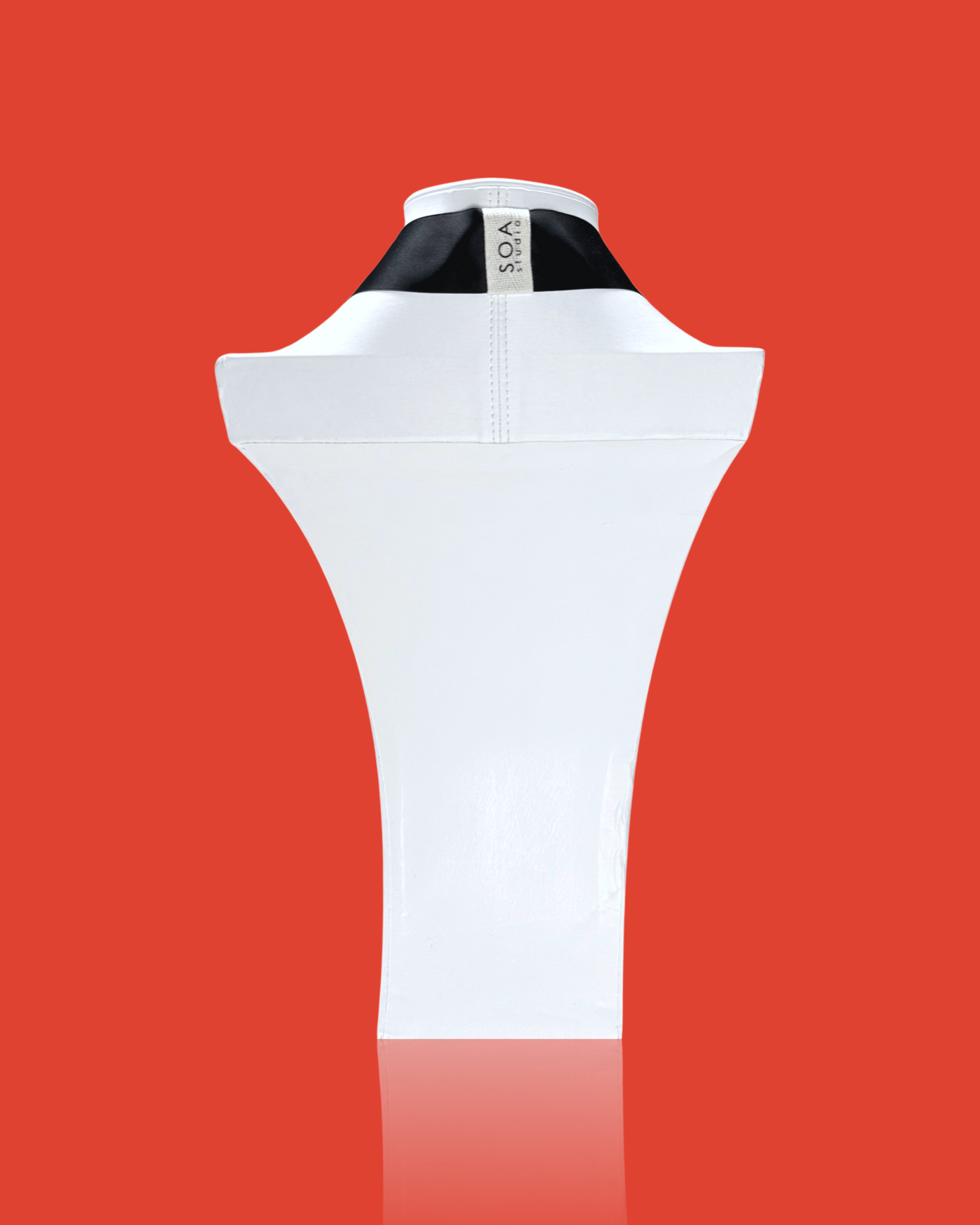 Minimal blob-shaped long necklace with a small white red pendant, acrylic design, and hand-made silk ribbon fastening.
