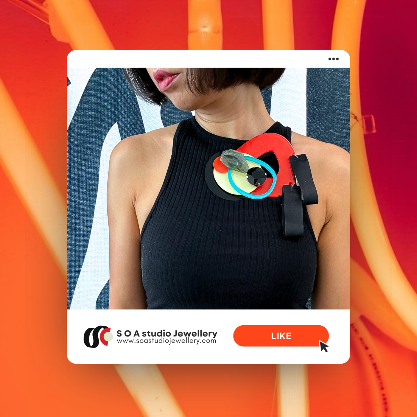Detachable scarlet necklace brooch with geometric shape and marble pattern on black dress.