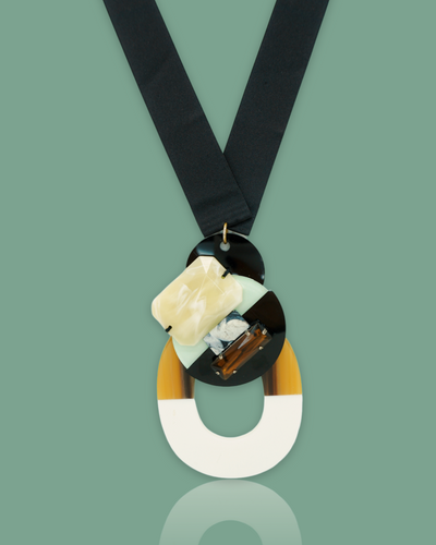Chic bold classy mint necklace with buffalo horn pendant, gem stones, black sequins, and silk ribbon.