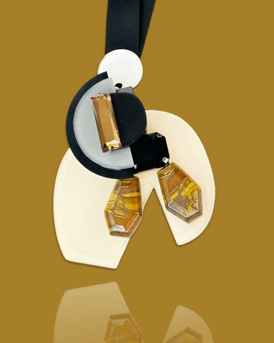 Abstract elegant necklace with cream and black accents, featuring gold pendant and hand-made irregular shape acrylic and gem design.