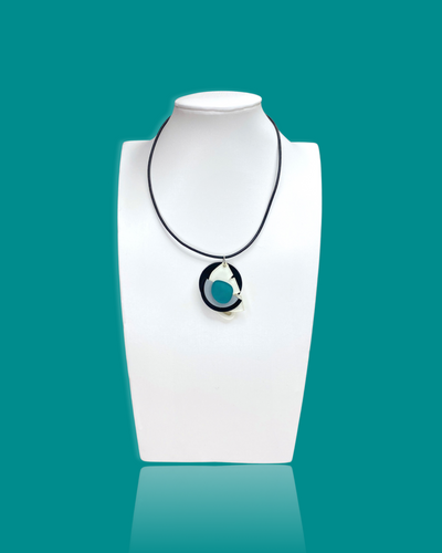 Subtle trendy small pendant necklace in ocean colour on display mannequin.