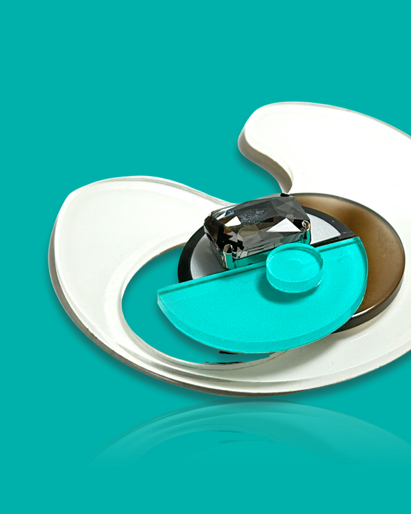 Geometric-shaped trendy brooch in cyan and white with abstract design and gemstone.