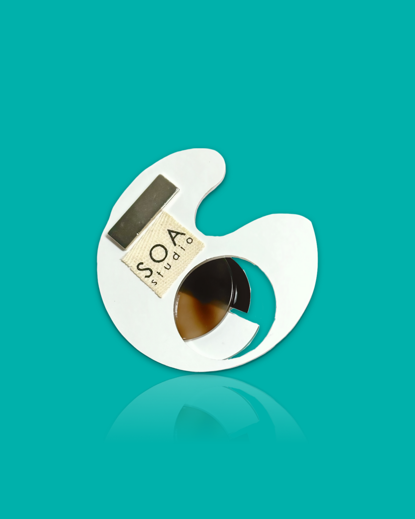 Geometric-shaped trendy brooch in cyan and white with irregular acrylic design.