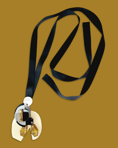 Abstract elegant necklace with creamy color, black and gold pendant, irregular acrylic gem, and silk ribbon.