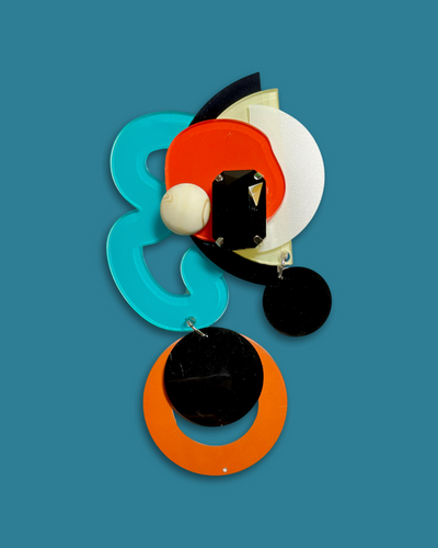 Geometric-shaped fashion brooch in cerulean, hand-made with die-cut acrylic, sequins, and beads.