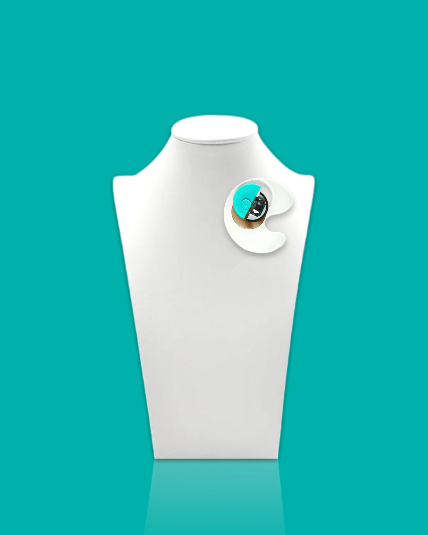 Geometric-shaped trendy brooch in cyan and white with abstract design on display stand.