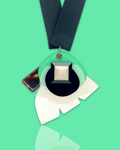 Stylish fashion necklace in seafoam color with acrylic hardware and silk ribbon fastening.