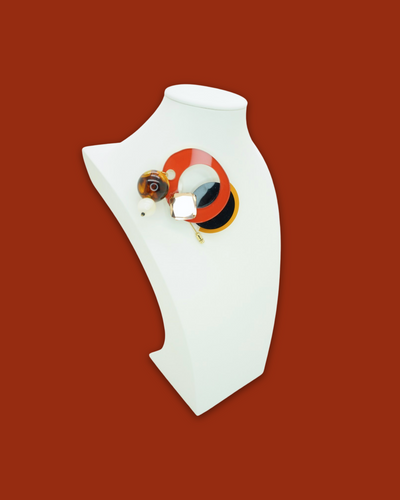 Elegant cherry-colored irregular-shaped brooch with beads and sequins on display.