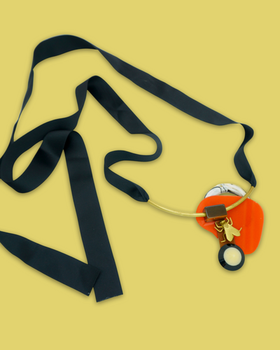 Sophisticated design necklace in squash colour with die-cut acrylic and silk ribbon.