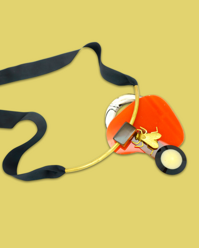 Sophisticated design necklace in squash colour with die-cut acrylic and silk ribbon.