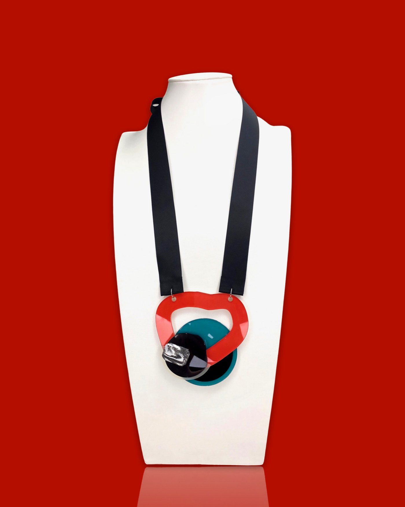 Geometric shape necklace in red with irregular acrylic hardware and black sequin accents.