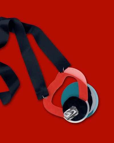 Geometric shape necklace in red with irregular acrylic hardware and black silk ribbon.