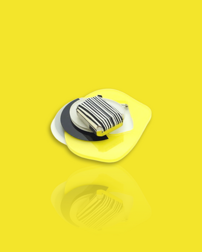 Avant-garde brooch with lemon-colored striped bead, featuring palladium, acrylic hardware, and sequins.