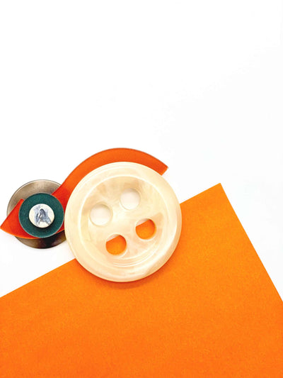 Bold button bar-pin brooch with tiger color, geometric design; features plastic beads and polymer clay.